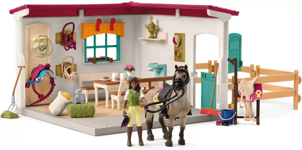dziewczynka bawi się figurkami koni Schleich